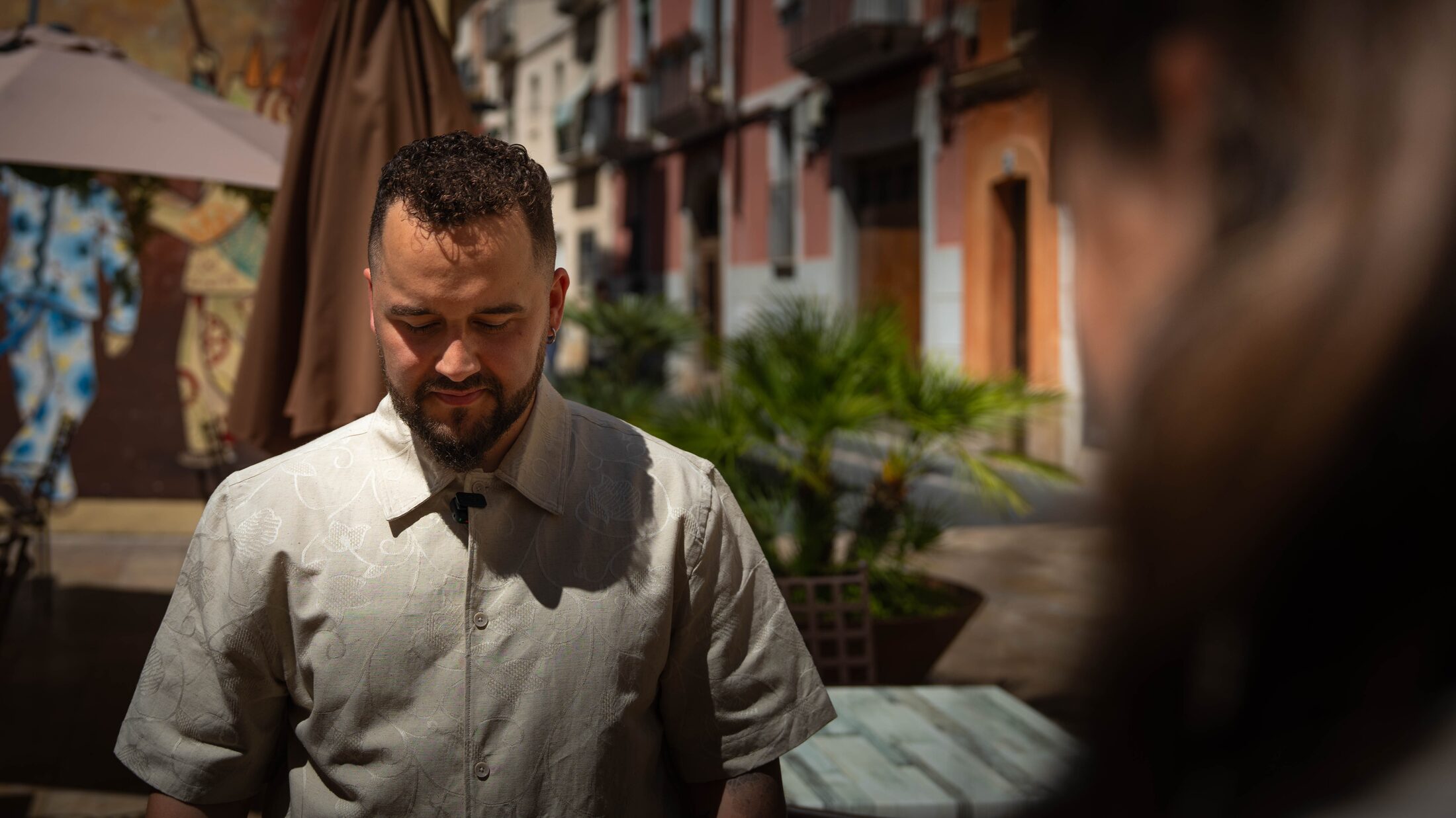 Retrato del novio en una calle de casco antiguo, luz de mediodía